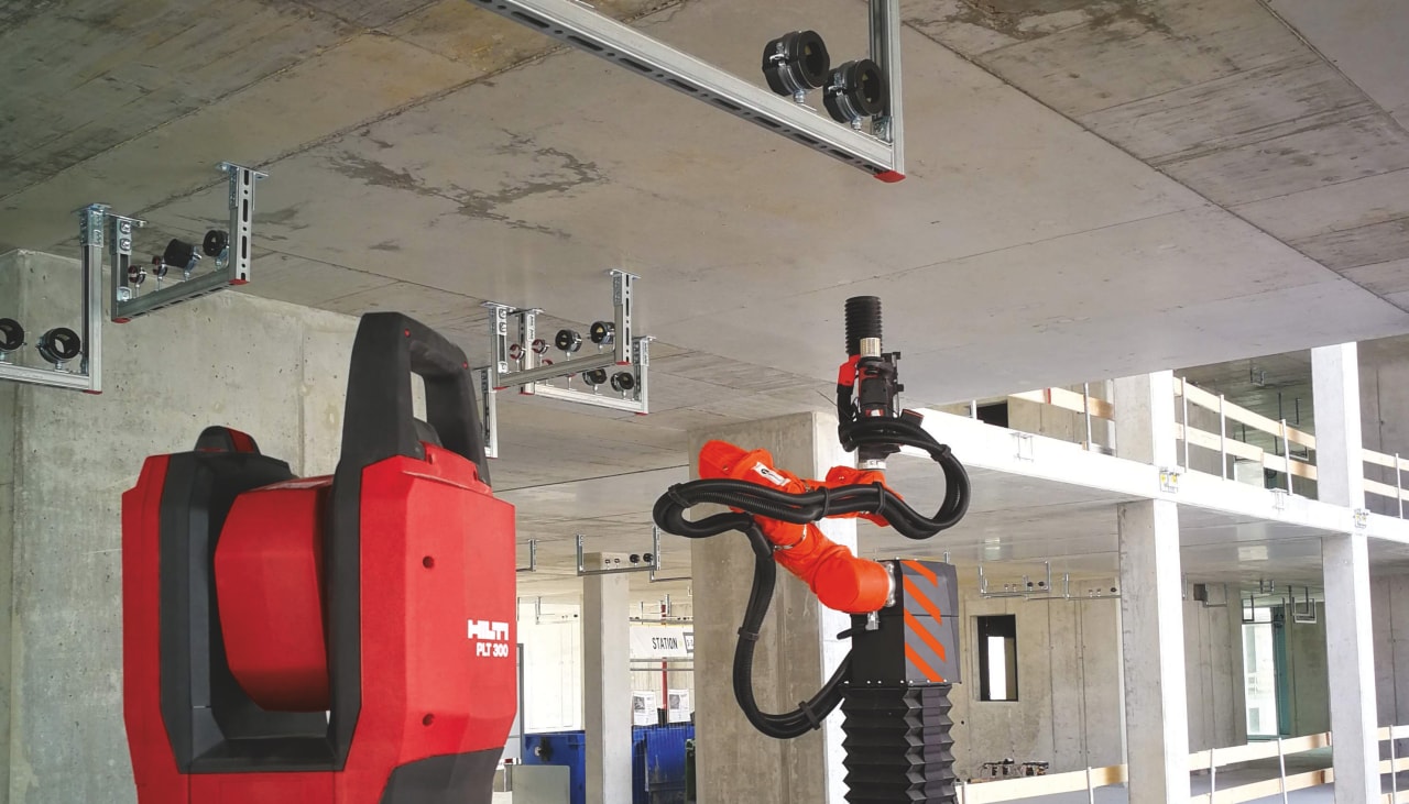MEP installation system, total station and drilling robot on a construction site